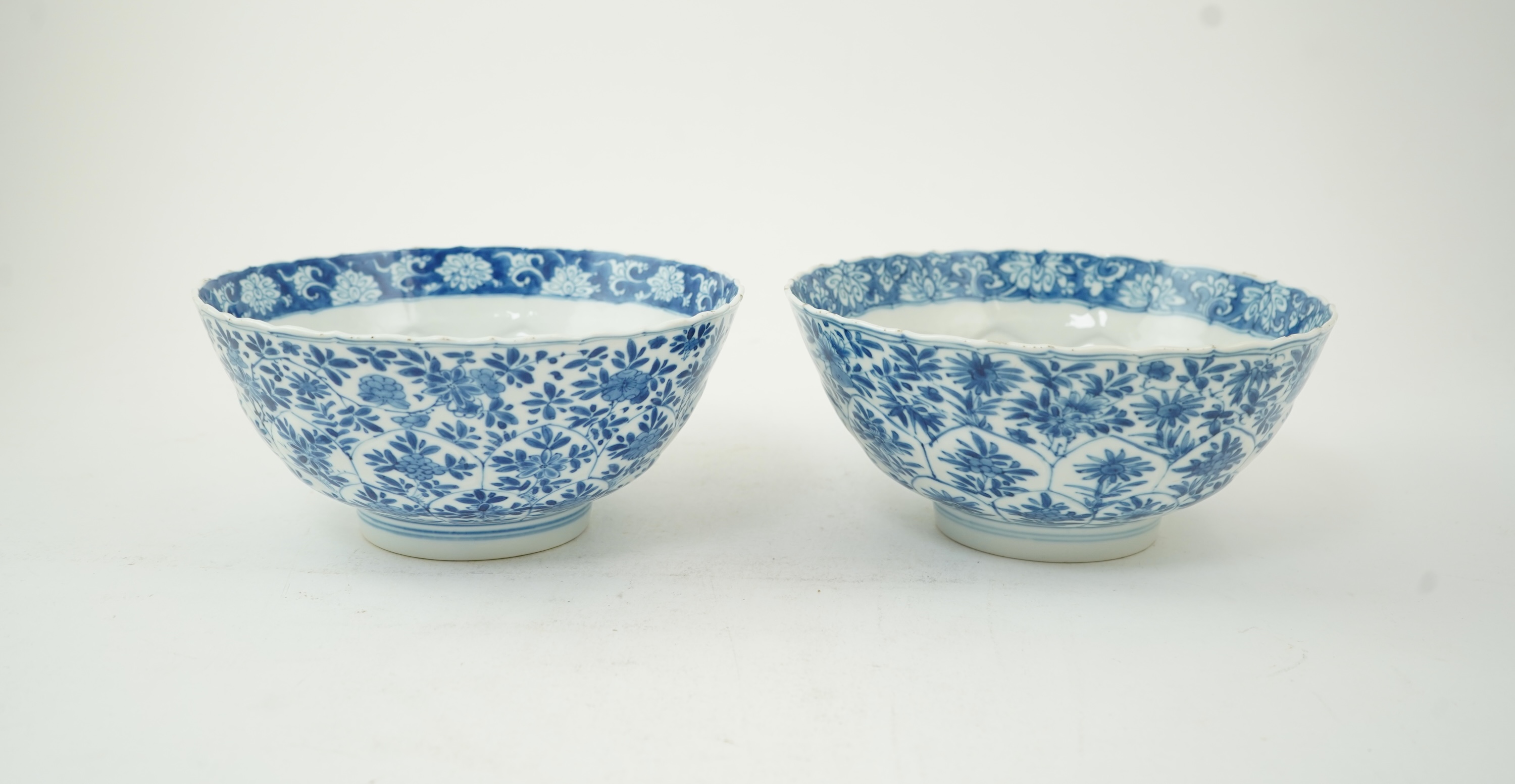 A near pair of Chinese blue and white lotus flower moulded bowls, Kangxi period
